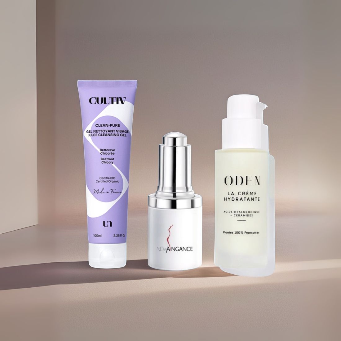 Three skincare products from Cultiv, New Angance, and Oden on a gradient background