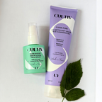 Two CULTIV skincare products arranged on a white background: a mint green bottle of Pure Boost Serum and a lavender tube of Clean Pure Face Cleansing Gel, with green leaves as styling props.