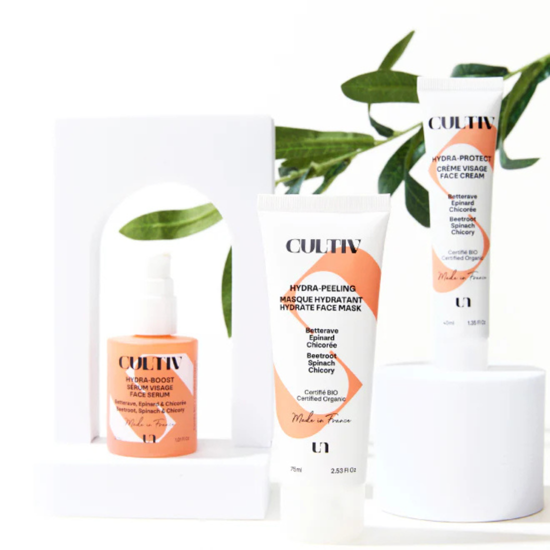 Cultiv skincare products with green leaves on a white background