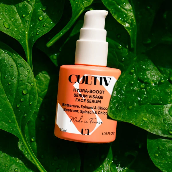 Cultiv Hydra-Boost Serum bottle on a leafy green background
