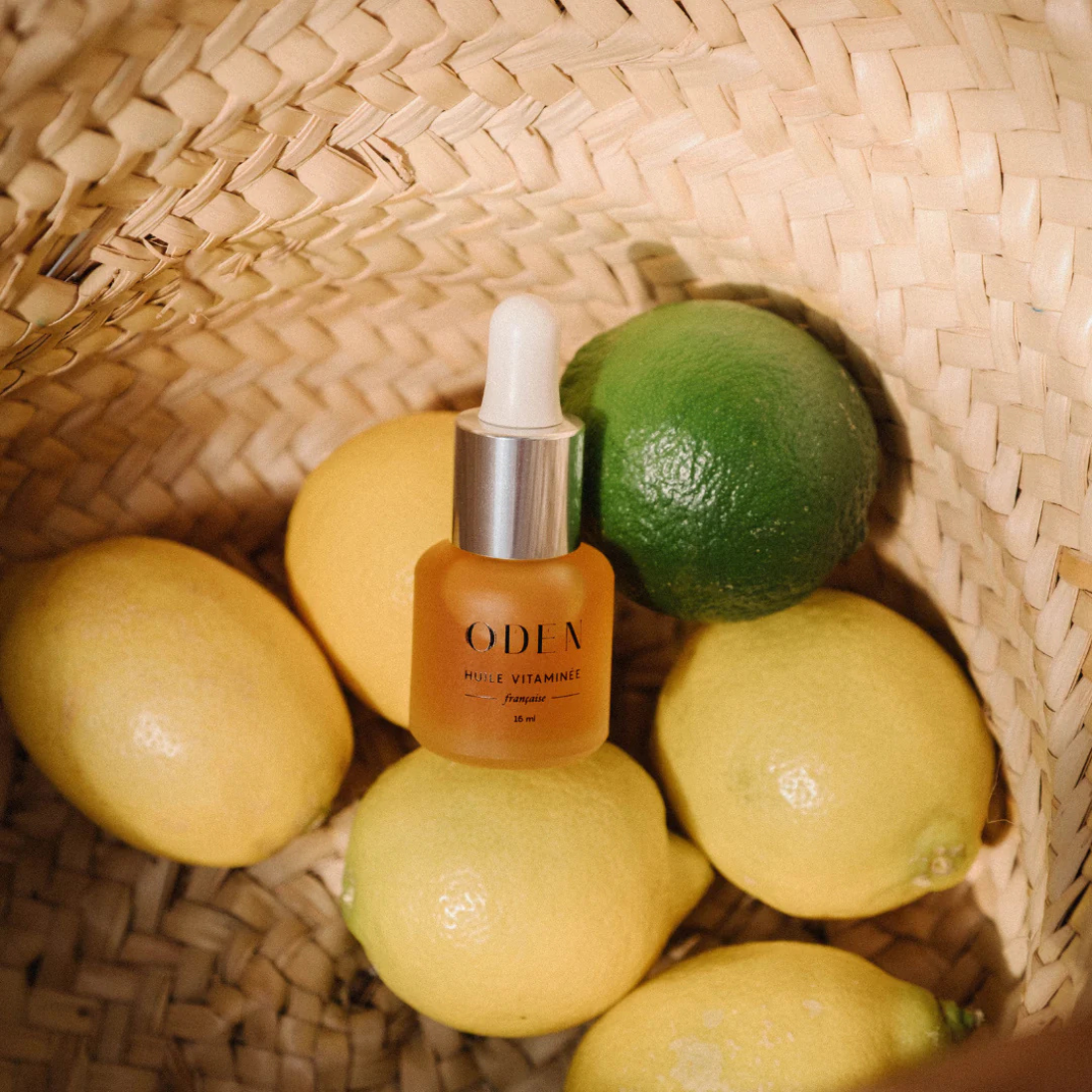 Oden_viatminoil bottle with lemons and limes in a woven basket